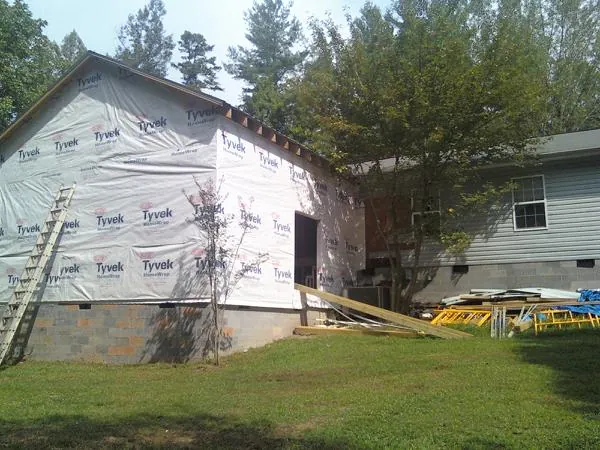 Tyvek wrapped gable on a new room addition beside an existing home in Mount Carmel