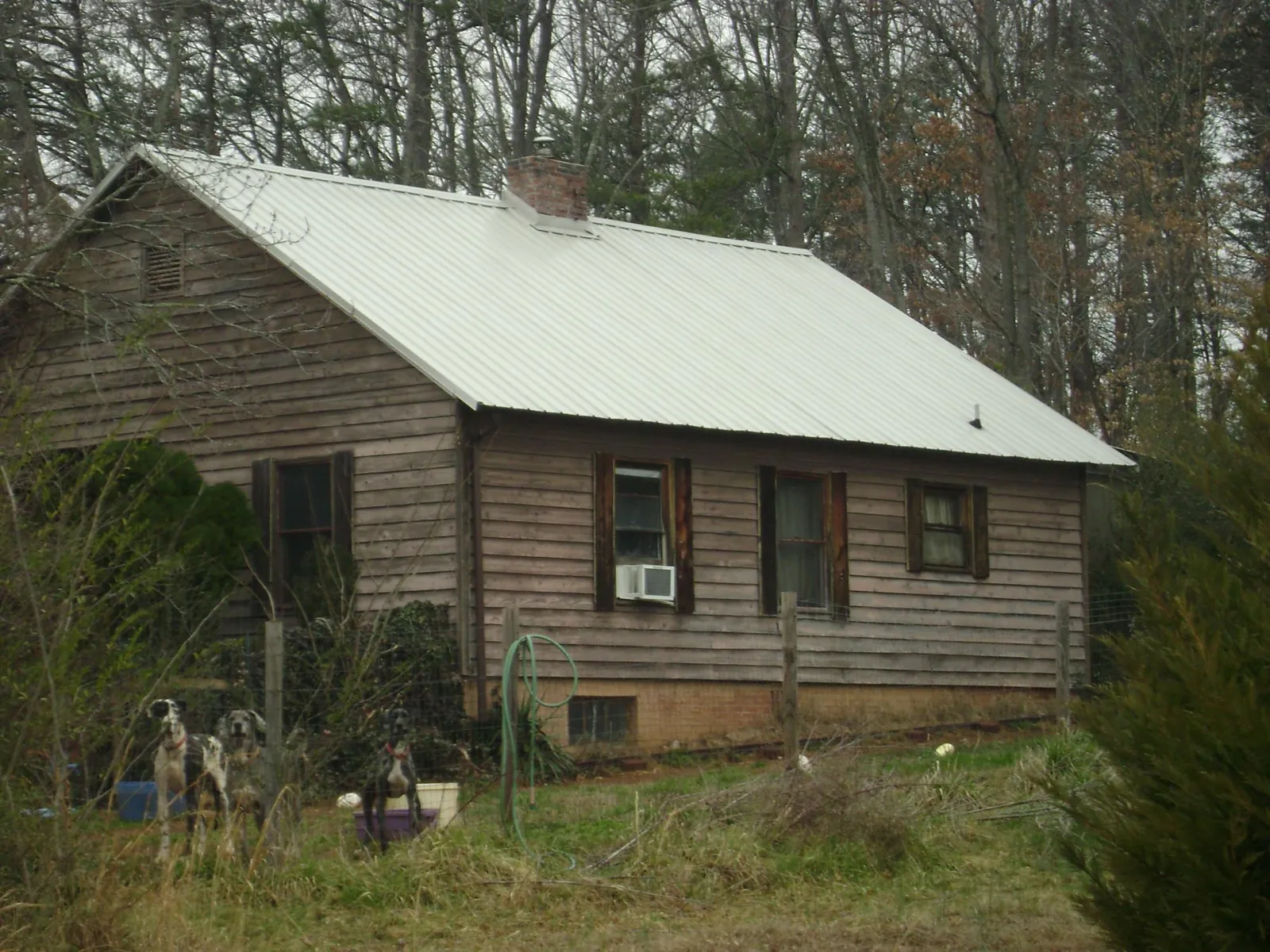 White metal roof on an old wood sided farmhouse, from a Metal Roof Installation job in Mount Carmel